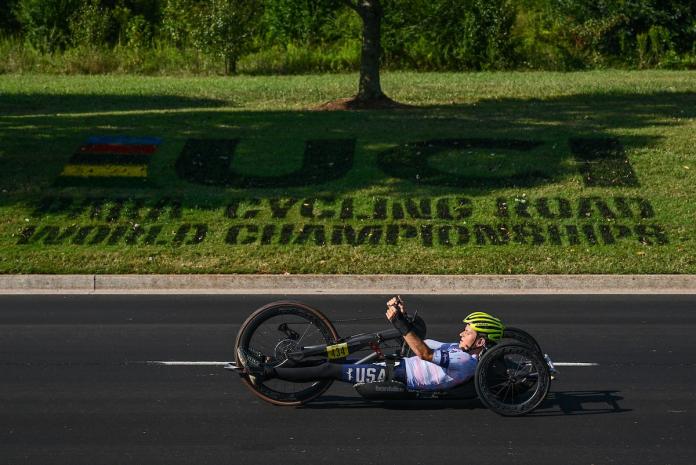 A female tricyclist is in action